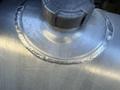 A metal fuel tank cap with clear labeling indicating warning information and capacity measurements