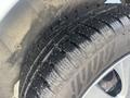 Close-up of a tire tread on a 2017 Ford Transit Connect showing detailed patterns and dirt accumulation on the surface