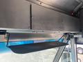 The image shows the interior of a 2012 Ford Econoline with a black sun visor attached to the overhead area near the windshield