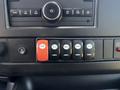 Dashboard controls of a 2020 Chevrolet Express featuring buttons for door, interior lights, auxiliary functions, heater, and a red switch