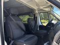 The interior of a 2016 RAM Promaster showing two front seats with seatbelts and a steering wheel visible in the driver's area