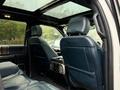 Interior view of a 2018 Ford F-150 showing two front seats with dark blue leather upholstery and a view of a panoramic sunroof above