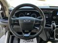 Steering wheel and dashboard of a 2021 Ford Transit featuring controls and a gear shifter