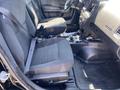 Interior view of a 2019 Dodge Charger showing two front seats with black fabric upholstery and seat belts