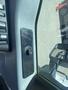 A close-up of the interior door panel of a 2016 Ford F-350 SD featuring a black control knob and vehicle controls