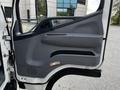 The interior door panel of a 2015 Mitsubishi Fuso FE featuring a gray design with a handle and speaker area