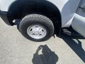 Close-up of a tire and wheel on a 2016 Ford F-350 SD showing a chrome wheel rim and a rugged tire tread
