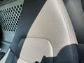 Close-up view of a gray leather seat in a 2014 Chevrolet Express van with visible stitching and texture