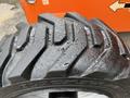 Close-up of a wet tire from a 2012 JLG 660SJ featuring deep treads designed for traction and stability