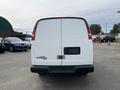 A white 2013 Chevrolet Express van viewed from the rear with a blank license plate area and no visible decals or markings
