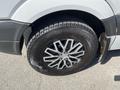 A close-up of a 2010 Mercedes-Benz Sprinter's alloy wheel and tire showing detailed tread patterns and shiny metal spokes