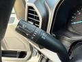 Close-up of a 2018 Ford F-350 turn signal and wiper control lever featuring various indicators for wipers and headlights