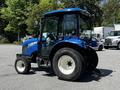 A blue 2018 New Holland Boomer 45 tractor with a cab and oversized tires showcasing a compact design and notable engine hood