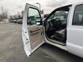 A 2010 Ford F-250 SD with an open door revealing the interior featuring a steering wheel and dashboard