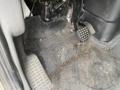 Interior floor of a 2014 International Durastar showing muddy floor mats and visible pedal assembly