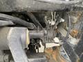 Close-up of a 2016 New Holland T475 tractor's mechanical components showing pipes and a valve assembly