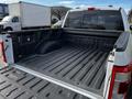 2021 Ford F-150 truck bed showing a clean, lined interior with a Ford logo on the side