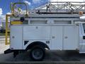 A 2008 Ford F-550 with a utility body featuring multiple storage compartments and a mounted aerial ladder on top