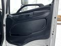 A black interior door panel of a 2019 Hino 338 with a handle and armrest designed for a cube truck