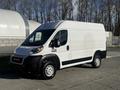 A white 2021 RAM Promaster van with a sleek design and black accents parked in a well-lit area