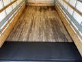 A 2017 Hino 155 truck interior with a wooden floor and a textured black loading ramp at the rear