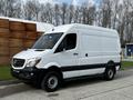 A 2017 Mercedes-Benz Sprinter van with a white exterior and black accents parked on a surface, featuring a streamlined design and large cargo area