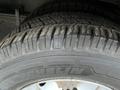 Close-up of a Michelin tire mounted on a wheel of a 2017 Chevrolet Express showing tread patterns and details of the rubber surface