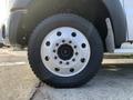 A close-up of a tire and wheel from a 2013 Ford F-450 SD showcasing the wheel design and tread pattern