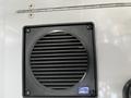 A black speaker grill mounted on a white surface with a blue label reading CBS240