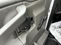 Close-up of the door handle and lock mechanism inside a 2017 Chevrolet Express van