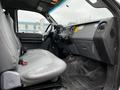 Interior of a 2013 Ford F-650 showing the driver's seat and dashboard with black and gray tones and a simple layout