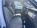 The interior of a 2013 Ford Expedition featuring two front seats with light gray upholstery and a dashboard with a central console and control panel