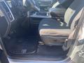 A 2021 RAM 1500 interior showing the driver's side with a black fabric seat a floor mat and control panel details
