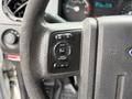 Close-up of the steering wheel of a 2012 Ford F-450 SD showing control buttons for cruise, setup, and reset functions