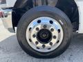 A close-up of a chrome wheel rim and tire from a 2020 Chevrolet Silverado showcasing the shiny surface and lug nuts