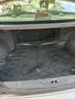 The trunk of a 2002 Nissan Maxima featuring a rubber mat with the word FORESTER embossed on it