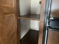 Interior storage shelves inside a 2016 Jayco 265RLSW with a wooden finish and a simple design