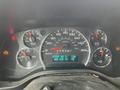 Dashboard of a 2014 GMC Savana displaying speedometer fuel gauge and warning lights with a message indicating low air pressure in the right rear tire