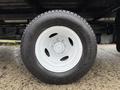 Close-up of a white wheel rim with a black tire showing tire tread details on a 2022 Ford Econoline