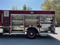 A 2006 Emergency One Fire Truck featuring an exposed side compartment with various controls gauges and equipment organized on a metal surface