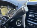 Close-up of the gear shift lever in a 2022 RAM 3500 with a textured grip and metallic accents