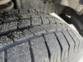 Close-up of a tread pattern on a tire belonging to a 2009 Ford Econoline showing visible wear and dirt on the rubber surface