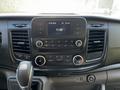 Dashboard of a 2023 Ford Transit with a touchscreen display and various control buttons for audio and climate settings