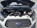 A 2016 Ford Transit engine bay with visible components including the engine, air intake, and several fluid reservoirs