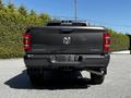 A gray 2022 RAM 3500 truck viewed from the rear showcasing its tailgate and bumper