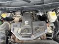 Close-up of the engine compartment of a 2011 Dodge Ram 5500 showcasing the 6.7L turbo diesel engine and various components including hoses and fluid reservoirs
