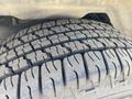 Close-up of a tire tread from a 2013 Ford Expedition showcasing the detailed patterns and grooves designed for traction on the road