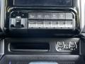 The dashboard buttons and control panel of a 2022 RAM 3500 displaying various auxiliary switches including trailer height and tow/haul settings