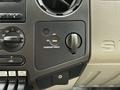 Dashboard controls of a 2008 Ford F-450 SD featuring air conditioning and passenger airbag switch with a circular knob