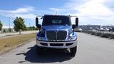 A blue and silver 2012 International DuraStar 4300 truck is facing the camera with visible headlights and a sleek front grille